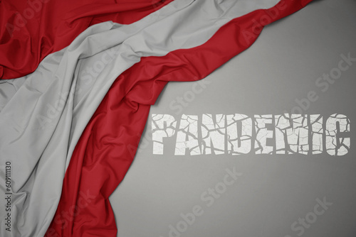 Photography waving colorful national flag of austria on a gray background with broken text pandemic