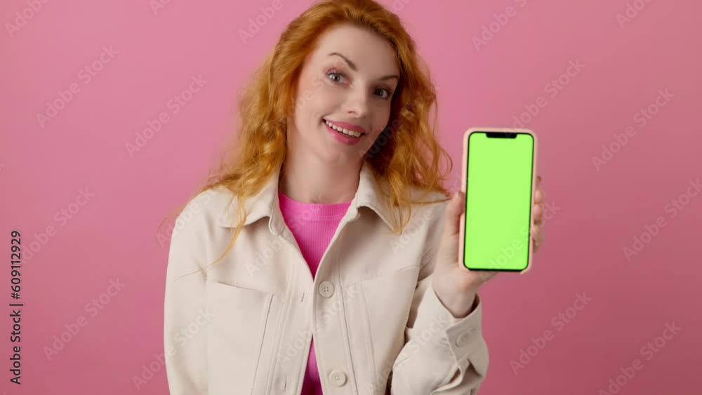 Advertising, green screen, chroma key and woman with phone for product placement, branding and mobile app marketing. Smiling lady female with mobile smartphone, studio isolated on pink background Advertising, green screen, chroma key and woman with phone for product placement, branding and mobile app marketing. Smiling lady female with mobile smartphone, studio isolated on pink background