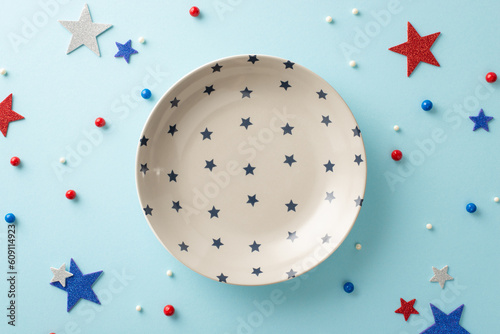 Obraz na plátne Make your table center of attention on Independence Day! From top view, array of patriotic accessories: plate, round sprinkles, glitter stars on pastel blue surface