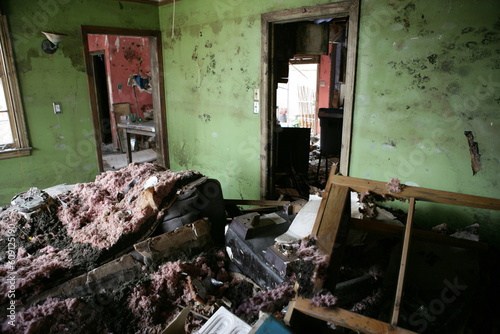 My Living room after hurricane Katrina.  Furniture is tossed about and then covered with fallen sheetrock and insulation. photo