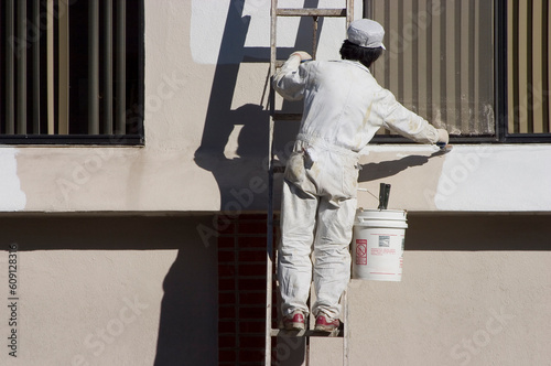 A painter applies a fresh coat of paint. photo