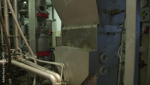 panning down medium shot of different ingredients being added in a mixer in a chocolate factory