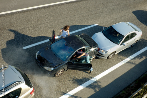 A small shunt on the freeway (motorway, autoroute, autobahn) a few seconds after it happened. Steam can be seen coming from under the bonnet of the black car. Motion blur on the passenger fleeing in p photo
