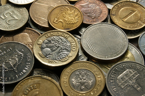A fragment of a coin pile. Coins of different countries. Background.