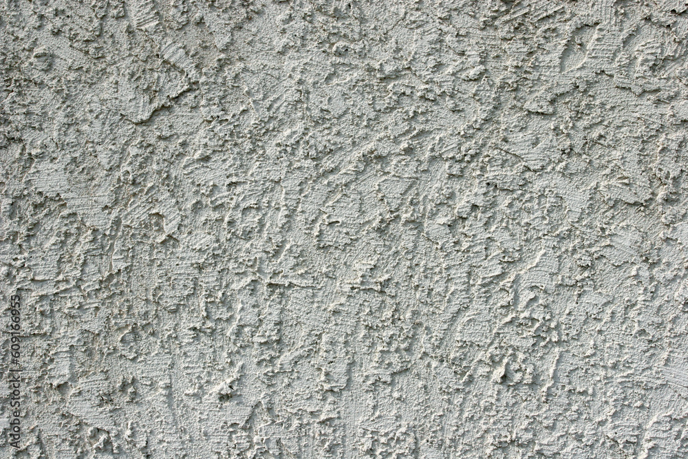 Closeup of gray stucco wall.