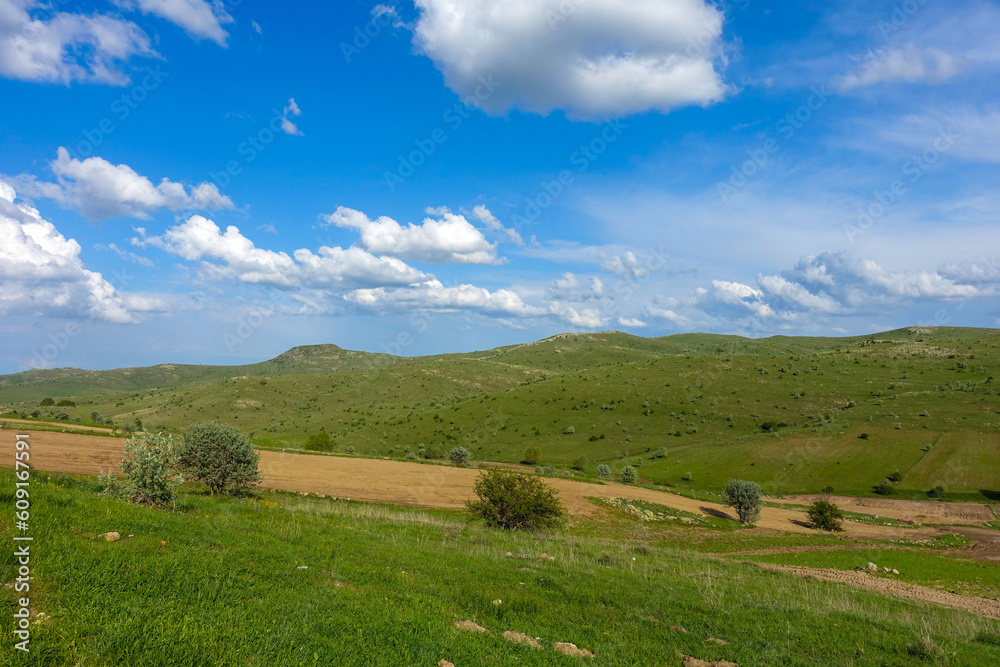 cloudy sky and green landscape, wonderful spring views, green field and hill plateau view,