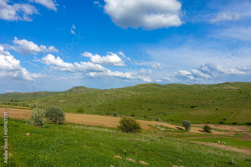 Obraz na płótnie cloudy sky and green landscape, wonderful spring views, green field and hill plateau view, w salonie