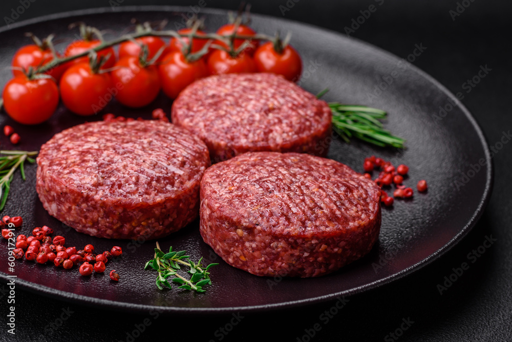 Fresh raw ground beef burger patty with salt and spices Fresh raw ground beef burger patty with salt and spices