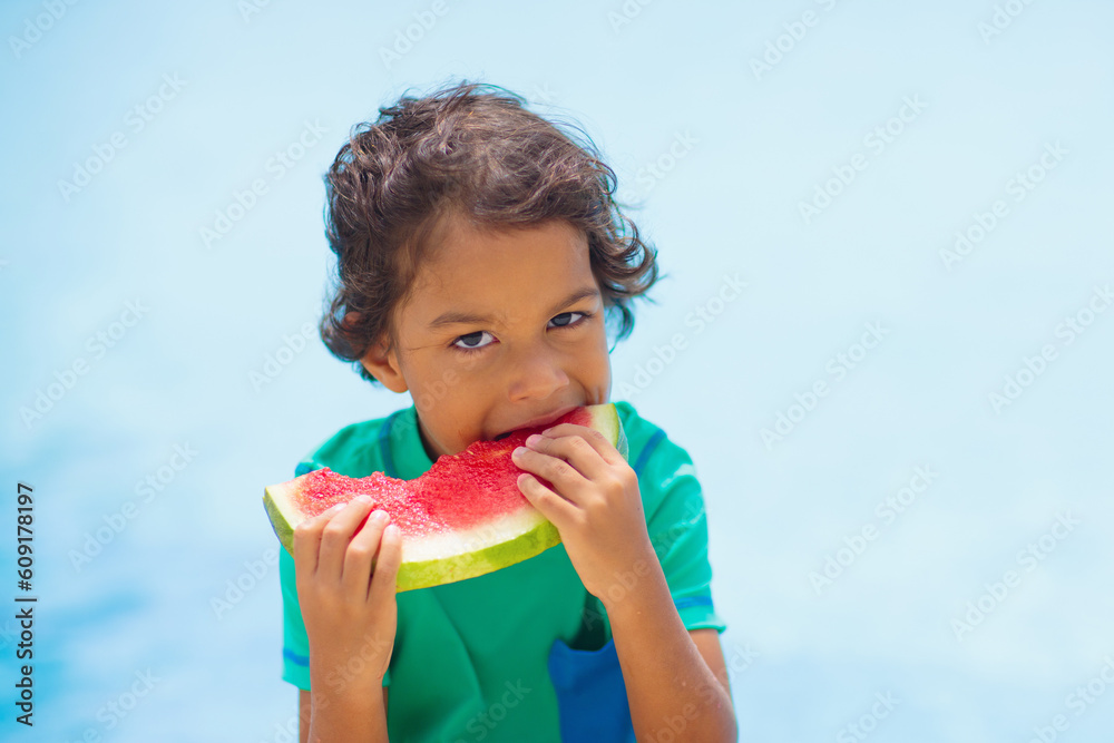 Child with watermelon in swimming pool Child with watermelon in swimming pool
