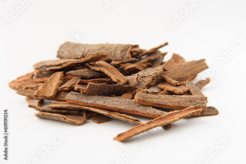 Cinnamon sticks chopped, isolated on white. Shallow depth of field, focused on the centre of the pile.