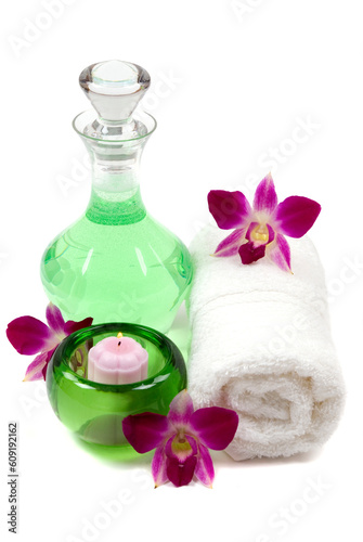 Orchids, towel, shower gel, and candle