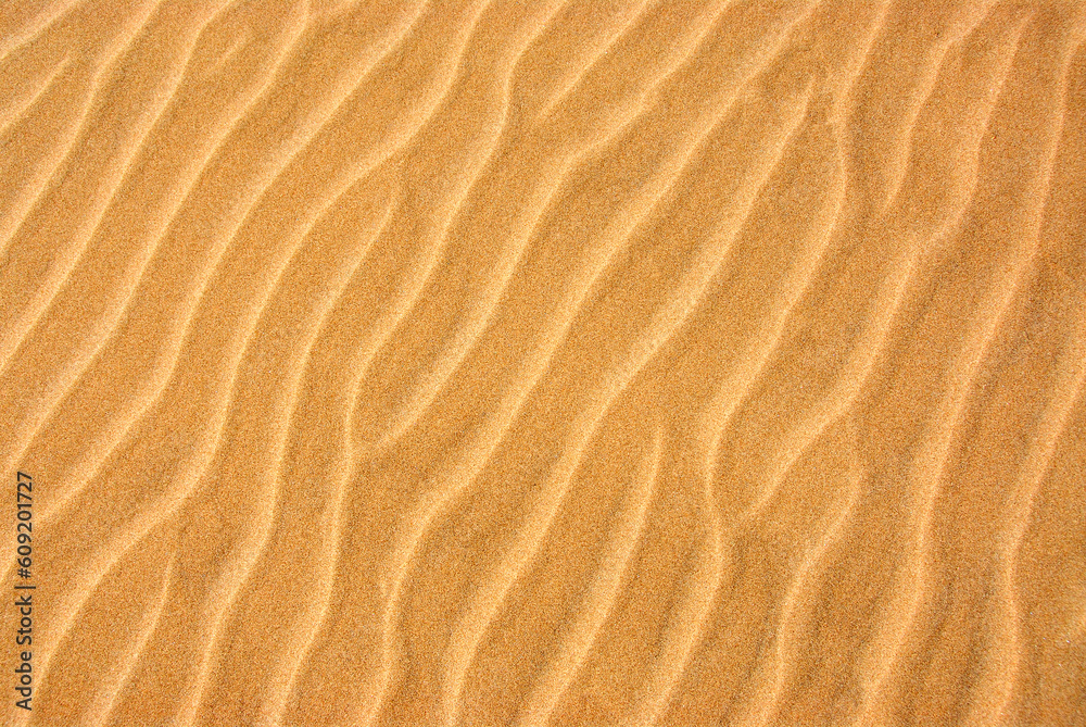 Background of a beautiful pattern on a yellow sand Background of a beautiful pattern on a yellow sand