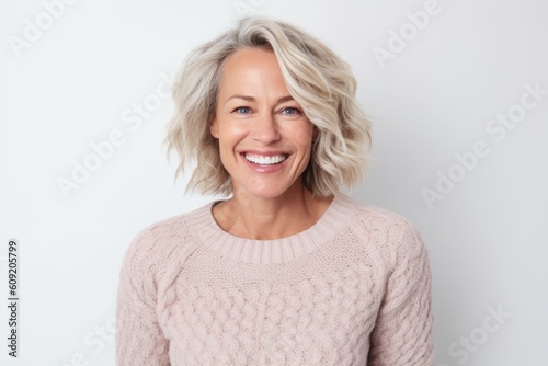 Portrait of smiling mature woman looking at camera isolated on a white background