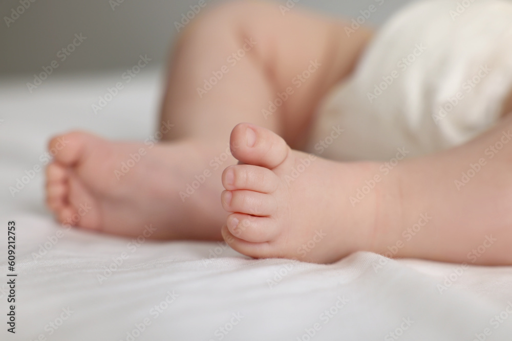 Cute little baby in diaper on bed, closeup Cute little baby in diaper on bed, closeup
