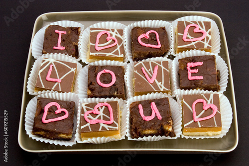Chocolate cakes with 'I love you' and 'love hearts' written in icing.