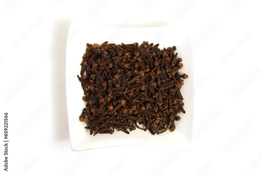 whole cloves in square white bowl isolated whole cloves in square white bowl isolated