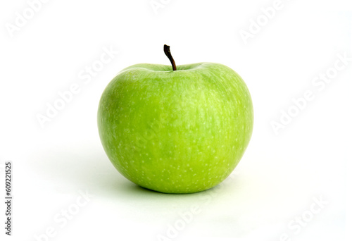 green sour apple against white background