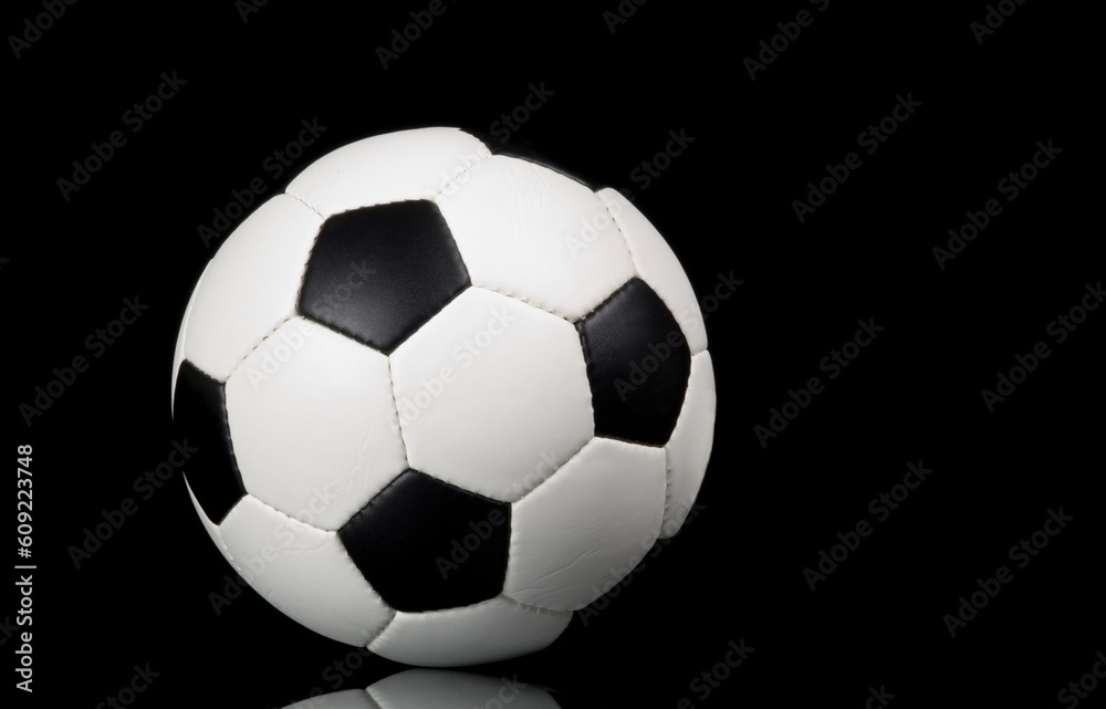 football - soccer ball on black background with reflection