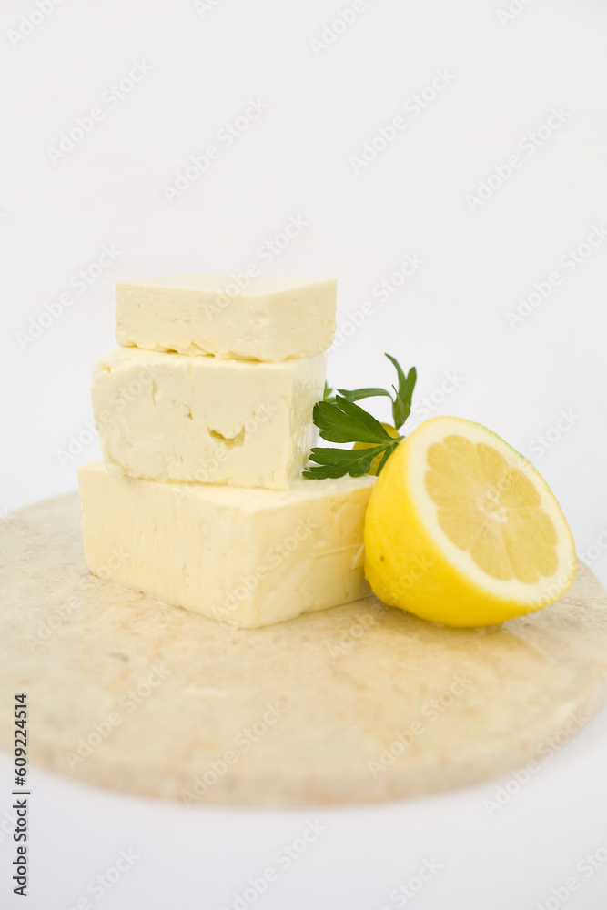 Fresh Feta Cheese Drizzled with Honey and Lemon on a marble cuting board. A healthy Cheese Plate, A great start to any salad.