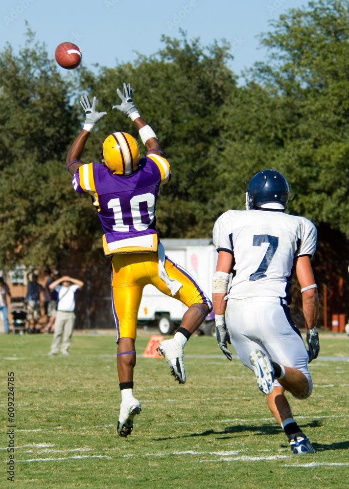 American football being played by young men on a sunny beautiful day American football being played by young men on a sunny beautiful day