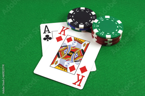 Fotografie Big Slick - Ace King with poker chips on a green poker baize