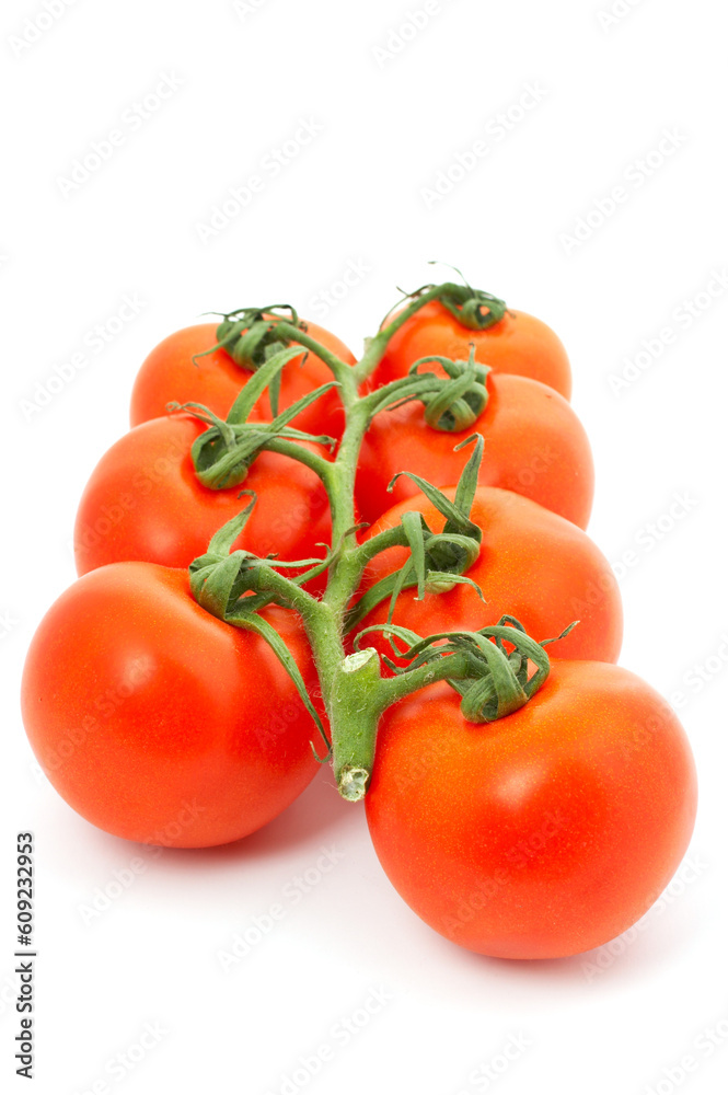 Seven red tomatoes on bunch with shadow over a white background Seven red tomatoes on bunch with shadow over a white background