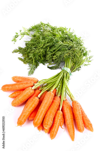 Bunch of fresh carrots with shadow on white background