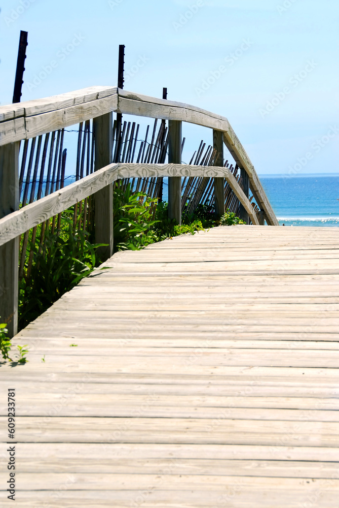 Wooden path over sand dunes with ocean view Wooden path over sand dunes with ocean view