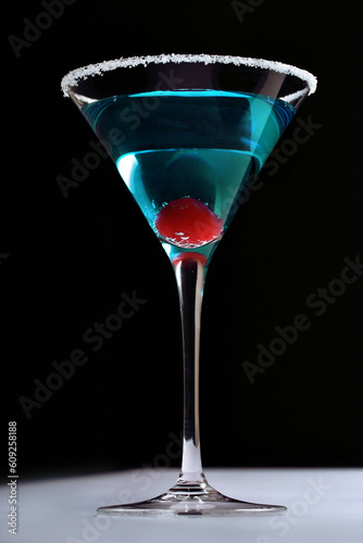 blue cocktail with red glace cherries