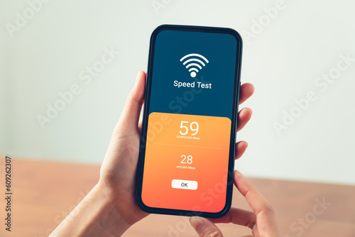 Hand using smartphone with showing WIFI speed test and loading bar for download software on internet or data form website.