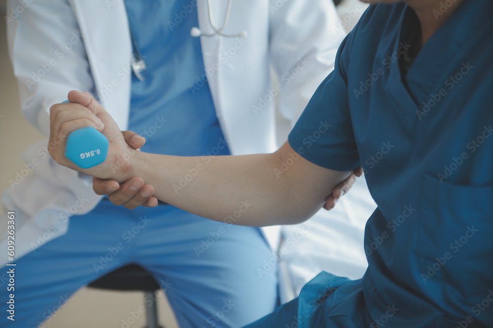 Physiotherapist working with patient in clinic Physiotherapist working with patient in clinic