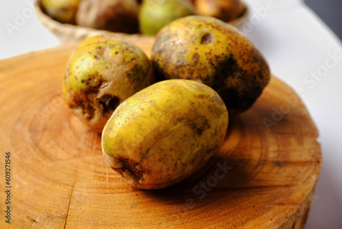 this is kedondong fruit or ambarella fruit on a wooden cutting board photo
