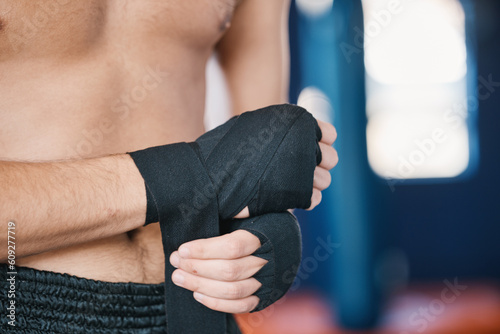 Fitness, boxing and man wrap hands with closeup in gym for training, workout and exercise. Sports, body builder and male athlete ready with bandage for boxer competition, practice and mma fight