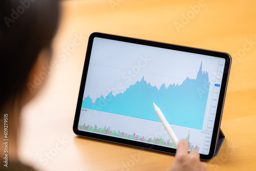 Woman look at the digital tablet with stock market data