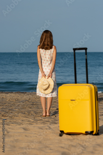 woman on the beach with a suitcase