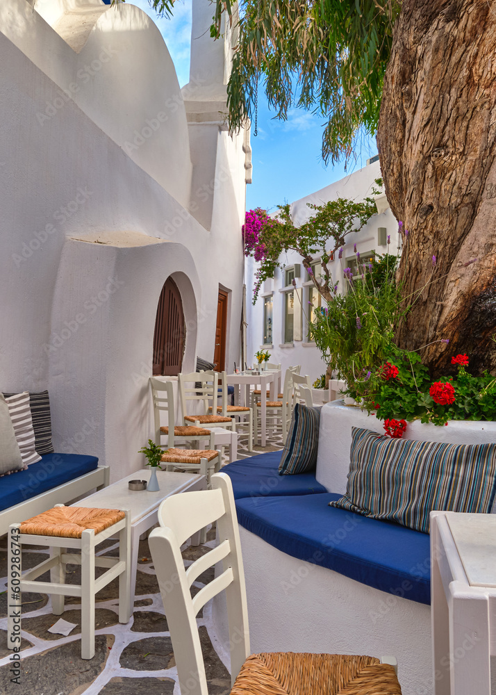 Cozy outdoor cafe or bar in Greek traditional town, Aegean island