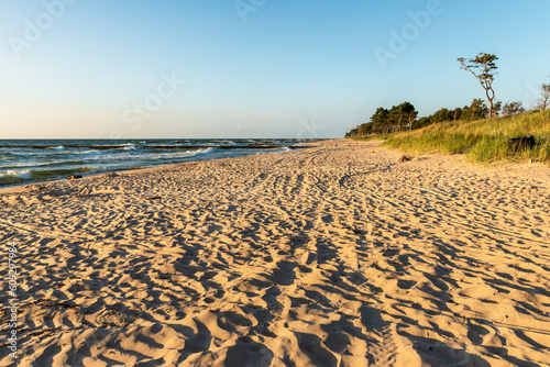 Fototapeta Naklejka Na Ścianę i Meble -  Beautiful empty beach at sunrise. Baltic Sea. golden sand. Darlowo, Poland