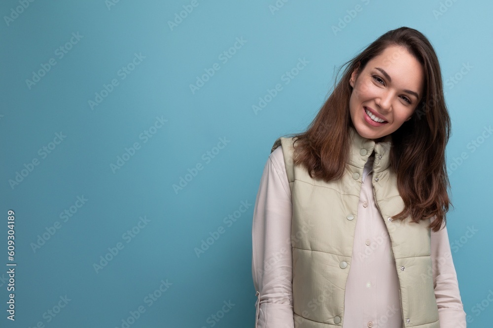 brunette woman with Hollywood smile posing on blue background brunette woman with Hollywood smile posing on blue background