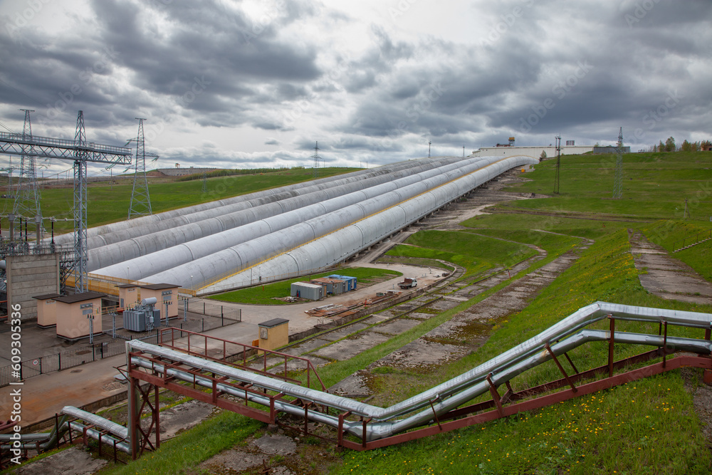hydro power plant pipes on grey sky background hydro power plant pipes on grey sky background