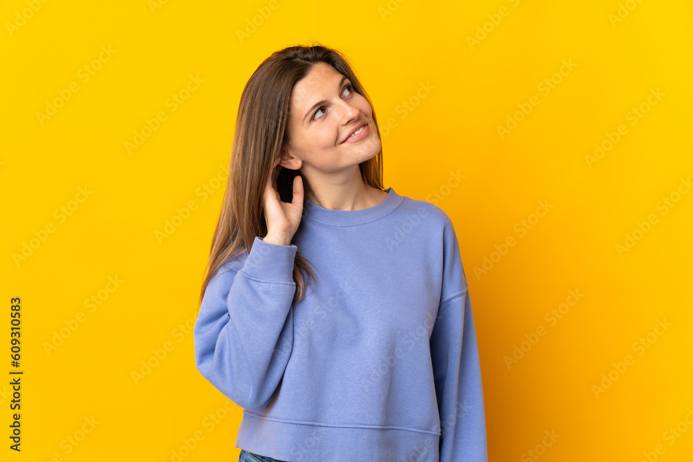 Young Slovak woman isolated on yellow background thinking an idea Young Slovak woman isolated on yellow background thinking an idea