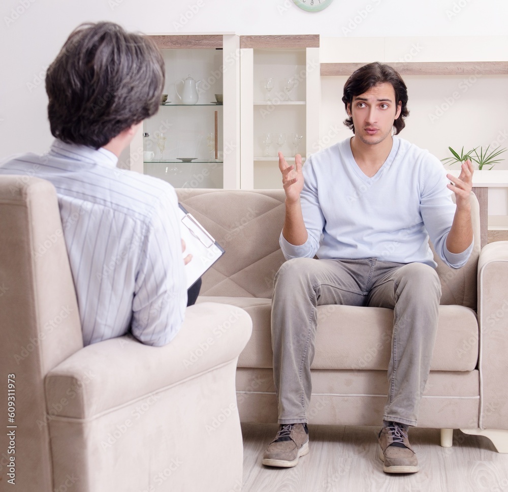 Young male patient discussing with psychologist personal problem Young male patient discussing with psychologist personal problem