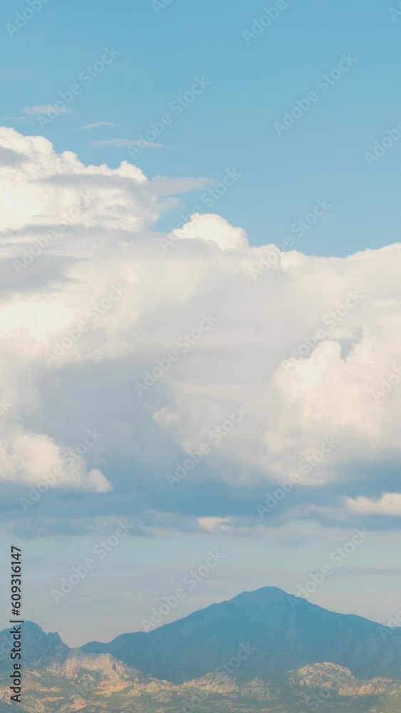 Clouds gather over the mountains, time lapse. Vertical video Social Media