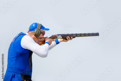 Clay pigeon shooting. An athlete shoots a gun at moving targets, sport gun shooting, clay pigeon shooting.