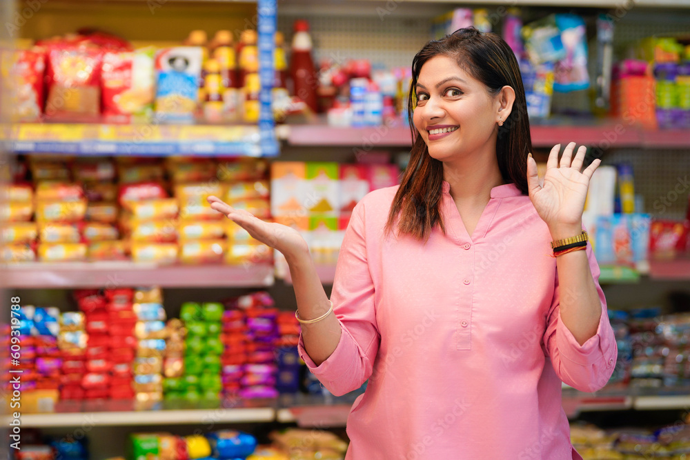 Indian woman giving expression for amazing offers and discount at grocery shop.