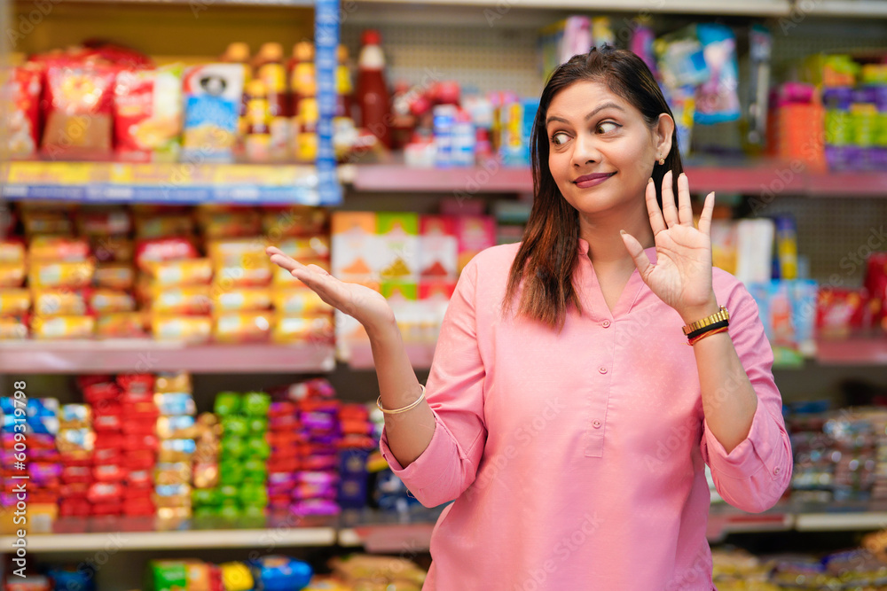 Indian woman giving expression for amazing offers and discount at grocery shop.