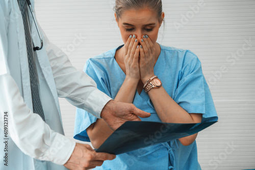 Doctor and unhappy patient at hospital or medical clinic . Healthcare medical malpractice and failure concept. Jivy photo