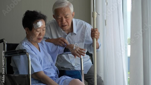 Asian senior lover couple support care husband visit accident injure wife at hospital good partner relationship photo