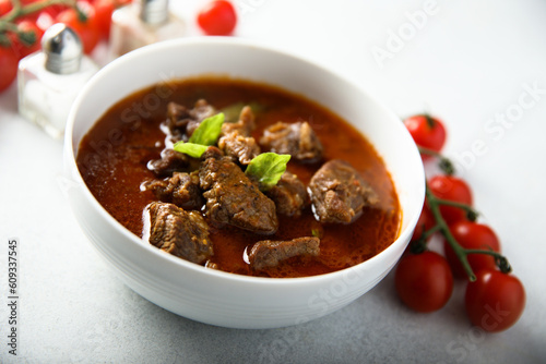 Homemade beef goulash with fresh basil