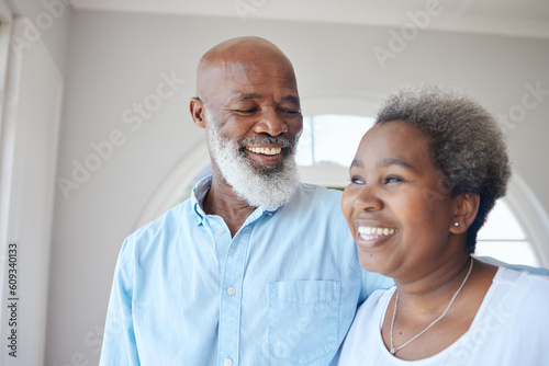 Senior black couple, smile and together in a happy home with love, care and commitment. Face of an african woman and man thinking about marriage, retirement lifestyle and happiness with a hug