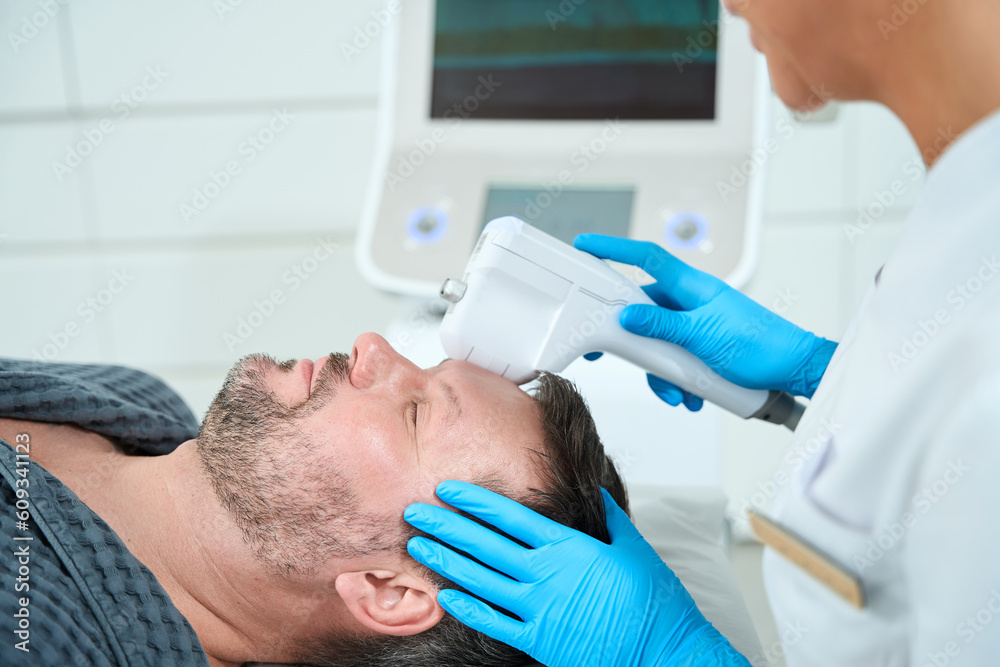 Middle-aged male on the mass lifting procedure Middle-aged male on the mass lifting procedure